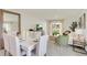 Bright dining room with white table and chairs, overlooking the living room at 316 Pelham Park Dr, Deland, FL 32720