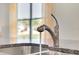 Modern kitchen sink with stainless steel faucet and granite countertop at 316 Pelham Park Dr, Deland, FL 32720