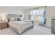 Spacious main bedroom with a large bed and gray upholstered headboard at 316 Pelham Park Dr, Deland, FL 32720