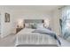 Spacious main bedroom with a large bed and gray upholstered headboard at 316 Pelham Park Dr, Deland, FL 32720