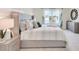 Spacious main bedroom with a king-size bed and an ensuite bathroom at 316 Pelham Park Dr, Deland, FL 32720