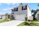 Two-story house with gray siding, brown shutters, and a two-car garage at 325 Pelham Park Dr, Deland, FL 32720