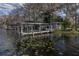 White wooden boat dock with covered shelter and gazebo at 3818 Kinsley Place, Winter Park, FL 32792