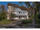 Two-story house with a wrap-around porch and large windows at 3818 Kinsley Place, Winter Park, FL 32792