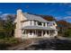 Two-story house with a wrap-around porch and large windows at 3818 Kinsley Place, Winter Park, FL 32792