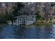 Rustic lakefront dock with gazebo and surrounding trees at 3818 Kinsley Place, Winter Park, FL 32792