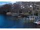 Several docks with boats and surrounding waterfront trees at 3818 Kinsley Place, Winter Park, FL 32792