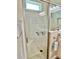 Walk-in shower with built-in seat and glass enclosure at 5114 Jareds Landing Way, Oxford, FL 34484