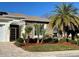 House exterior with stone and stucco, palm trees, and a white pergola at 5114 Jareds Landing Way, Oxford, FL 34484