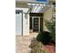 Front entry with a white pergola and glass door at 5114 Jareds Landing Way, Oxford, FL 34484