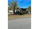 Landscaped front yard with palm trees and manicured lawn at 5114 Jareds Landing Way, Oxford, FL 34484