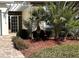 Landscaped entryway with a white pergola and tropical plants at 5114 Jareds Landing Way, Oxford, FL 34484