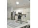 Modern kitchen with white cabinets and stainless steel appliances at 5114 Jareds Landing Way, Oxford, FL 34484