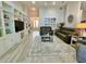 Bright living room featuring built-in shelving and hardwood floors at 5114 Jareds Landing Way, Oxford, FL 34484