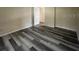 Bright bedroom with wood-look floors and an interior door at 5545 Devonbriar Way # 205, Orlando, FL 32822