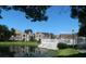 Building exterior showcasing pond and landscaping at 5545 Devonbriar Way # 205, Orlando, FL 32822