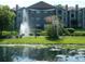 Apartment building with lake view and fountain at 5545 Devonbriar Way # 205, Orlando, FL 32822