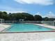 Community swimming pool with lounge chairs at 5545 Devonbriar Way # 205, Orlando, FL 32822