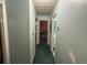 Long hallway with carpet and doors leading to bedrooms and a bathroom at 5690 Sw 202Nd Ct, Dunnellon, FL 34431