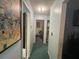 Home hallway with green carpet and artwork at 5690 Sw 202Nd Ct, Dunnellon, FL 34431