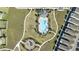 Drone's-eye view of a community pool and recreation area, showcasing playground and manicured landscaping at 581 Sun Warbler Way, St Cloud, FL 34771