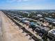 Aerial view of beachside community with colorful homes at 6110 S Atlantic Ave, New Smyrna Beach, FL 32169