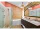 Spa-like bathroom with double vanity, large soaking tub, and bamboo feature wall at 6110 S Atlantic Ave, New Smyrna Beach, FL 32169