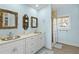 Bathroom with dual sinks, a walk-in shower, and beach-themed decor at 6110 S Atlantic Ave, New Smyrna Beach, FL 32169