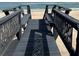 Dark stained wood beach deck with railings leading to the beach at 6110 S Atlantic Ave, New Smyrna Beach, FL 32169