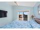 Main bedroom with a king-size bed and sliding glass door to balcony at 6110 S Atlantic Ave, New Smyrna Beach, FL 32169