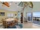 Dining area with spiral staircase and ocean view at 6110 S Atlantic Ave, New Smyrna Beach, FL 32169