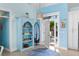 Bright and airy entryway with light blue walls, a surfboard, and built-in shelving at 6110 S Atlantic Ave, New Smyrna Beach, FL 32169