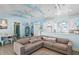 Open living room featuring a beige sectional sofa and light blue walls at 6110 S Atlantic Ave, New Smyrna Beach, FL 32169