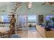 Living room with spiral staircase and ocean view at 6110 S Atlantic Ave, New Smyrna Beach, FL 32169