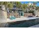 Relaxing pool area with wooden accents, seating, and a tranquil water feature at 6110 S Atlantic Ave, New Smyrna Beach, FL 32169