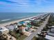 Expansive aerial view of the coastline, showcasing beach homes and ocean views at 6111 Turtlemound Rd, New Smyrna Beach, FL 32169