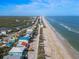 Aerial view of beachfront homes and coastal scenery at 6111 Turtlemound Rd, New Smyrna Beach, FL 32169