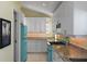 Bright kitchen featuring teal appliances and ample cabinet space at 6111 Turtlemound Rd, New Smyrna Beach, FL 32169