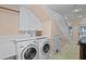 Bright laundry room with washer, dryer, and ample storage at 6111 Turtlemound Rd, New Smyrna Beach, FL 32169