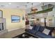 Bright living room featuring a unique canoe ceiling fan and spiral staircase at 6111 Turtlemound Rd, New Smyrna Beach, FL 32169