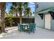 Outdoor patio with table and chairs, perfect for dining al fresco at 6111 Turtlemound Rd, New Smyrna Beach, FL 32169