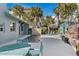 View of a freeform pool and patio area with lounge chairs at 6111 Turtlemound Rd, New Smyrna Beach, FL 32169