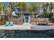 Inviting pool area with wooden wall and two teal chairs at 6111 Turtlemound Rd, New Smyrna Beach, FL 32169