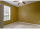 Bedroom with window, ceiling fan, and tile floors at 6240 Contessa Dr # 101, Orlando, FL 32829