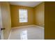 Simple bedroom with large window and neutral colored walls at 6240 Contessa Dr # 101, Orlando, FL 32829