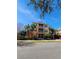 Three-story apartment building with yellow walls and palm trees at 6240 Contessa Dr # 101, Orlando, FL 32829