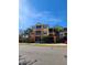 Three-story apartment building with yellow walls and palm trees at 6240 Contessa Dr # 101, Orlando, FL 32829