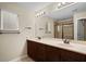 Bathroom with double sinks, large mirror, and shower at 6370 Golden Dewdrop Trl, Windermere, FL 34786