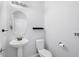 Clean and simple bathroom with pedestal sink and toilet at 6370 Golden Dewdrop Trl, Windermere, FL 34786