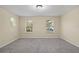 Spacious bedroom with two windows and gray carpet at 6370 Golden Dewdrop Trl, Windermere, FL 34786